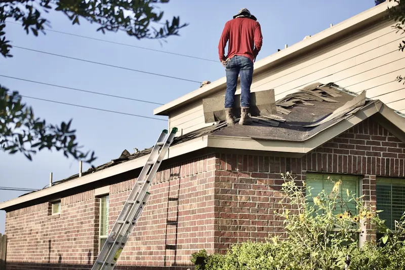 Professional roofer working on a residential roof in Fallmouth